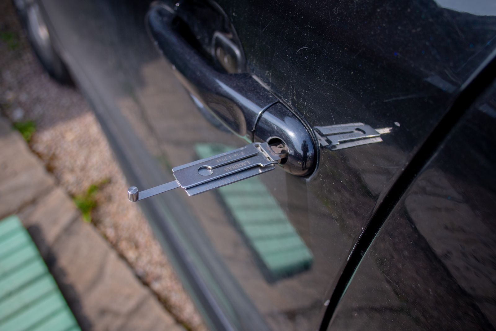 Close-up of a locksmith tool inserted into a car door lock — illustrative stock photo, not a photo of 95 Locksmith or its technician.