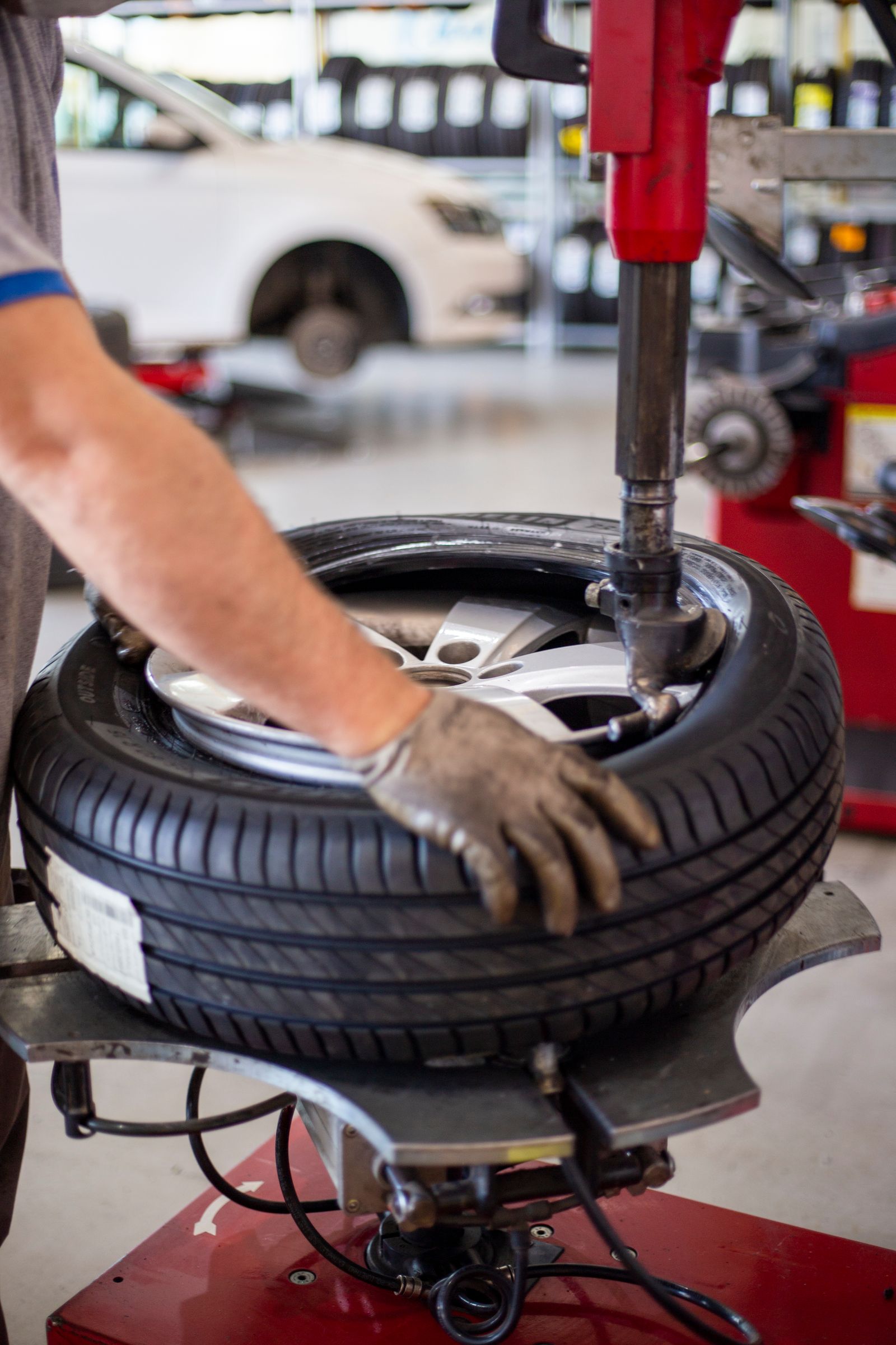 A mechanic changing a car tire with precision equipment in a workshop — illustrative stock photo, not a photo of A&L Tire Shop or its staff.