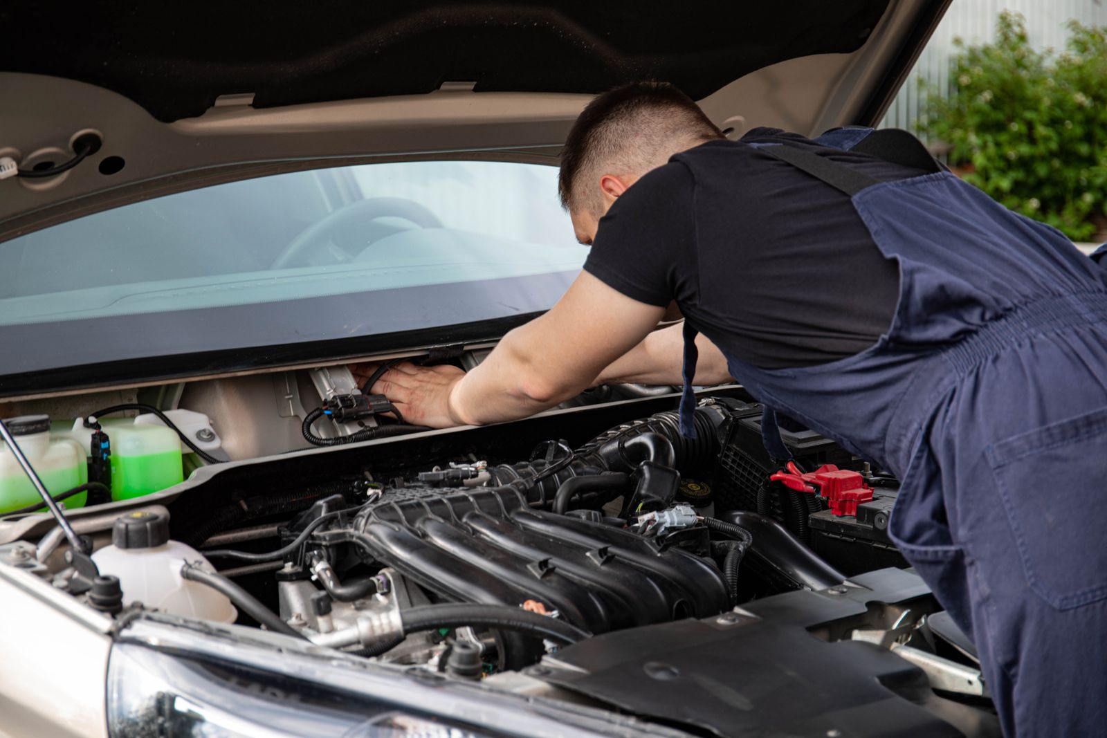 A mechanic works under the hood of a car — illustrative stock photo, not a photo of Bos Garage or its owner.
