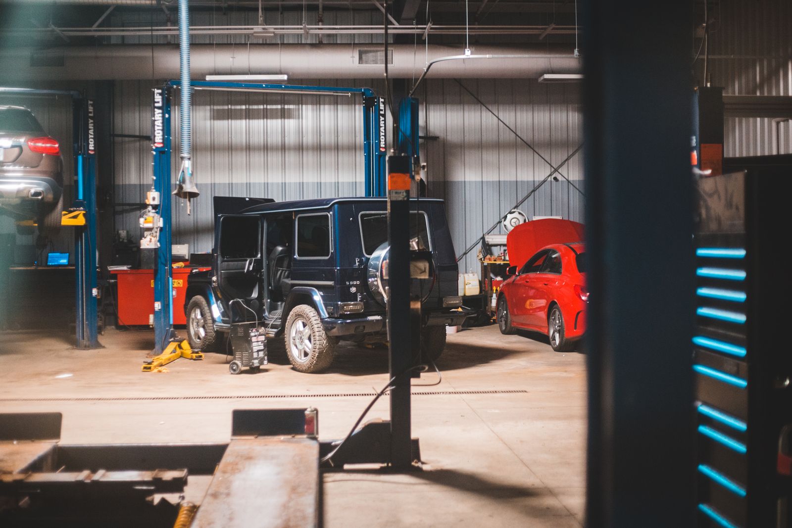 A multi-bay repair shop floor with vehicles on lifts — illustrative stock photo, not a photo of Brazos Valley Automotive's actual shop.