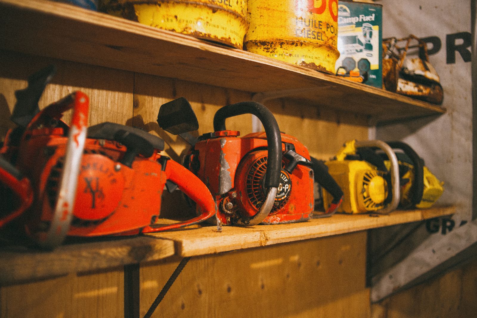A shelf of small engines and vintage chainsaws in a repair workshop — illustrative stock photo, not Bryan Outboard's own shop.