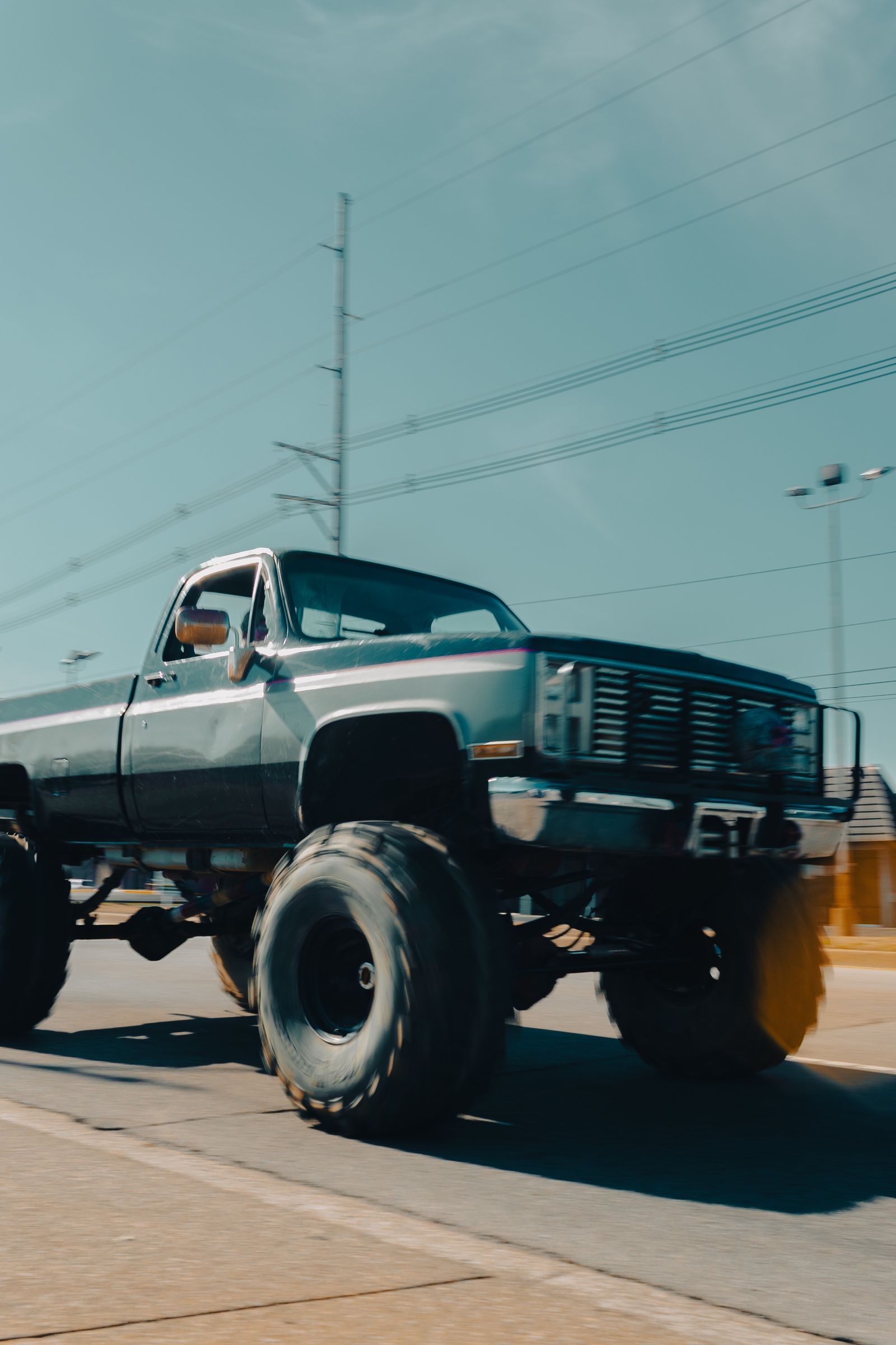 A heavily lifted pickup truck with oversized off-road tires — illustrative stock photo, not a photo of a Limitless Diesel & Offroad build.