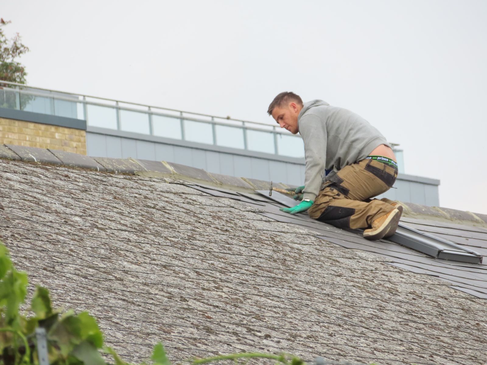 A construction worker installing shingles on a rooftop — illustrative stock photo, not a photo of Raul Lopez or Lopez Roofing's own crew.