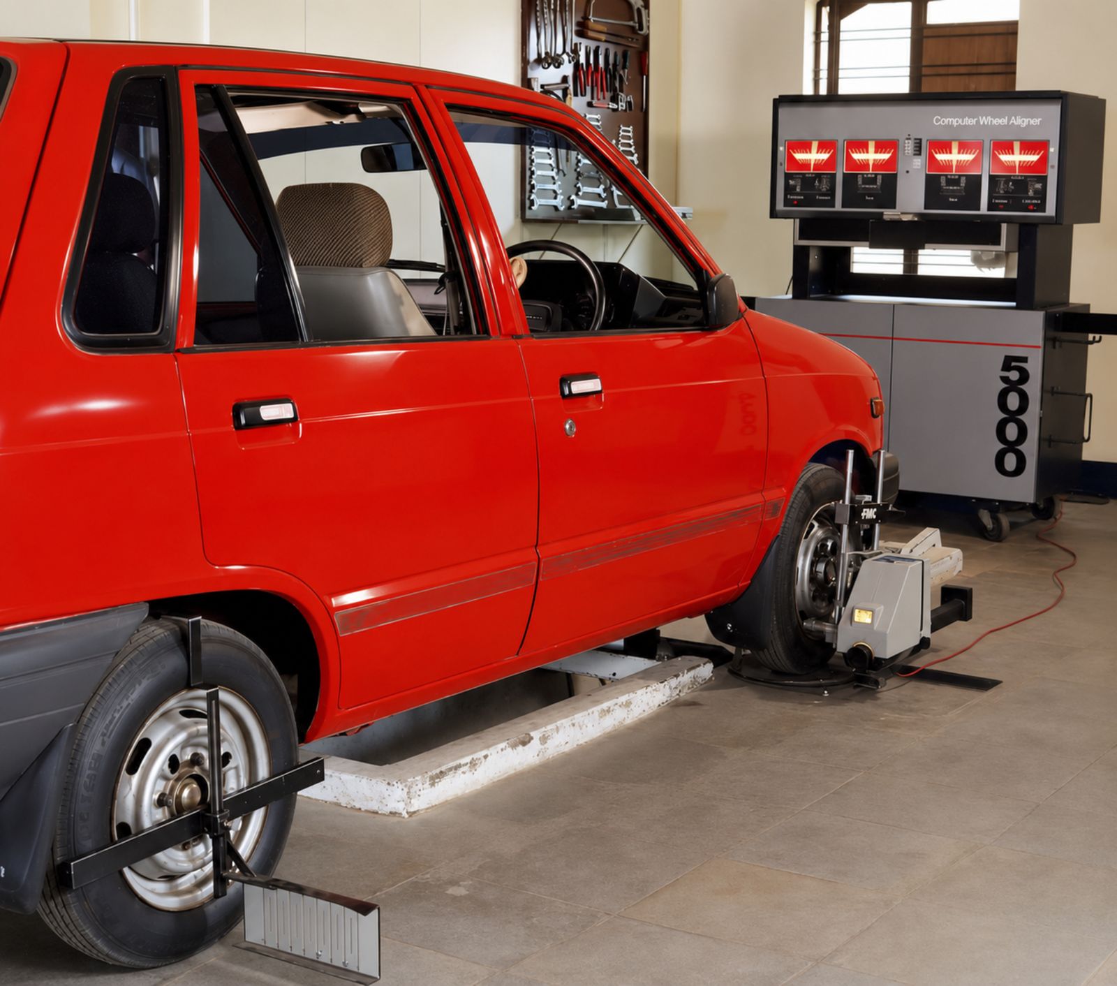 A car undergoing computerized wheel alignment service in an automotive workshop — illustrative stock photo, not a photo of Mansel's Wheel Alignment or its shop.