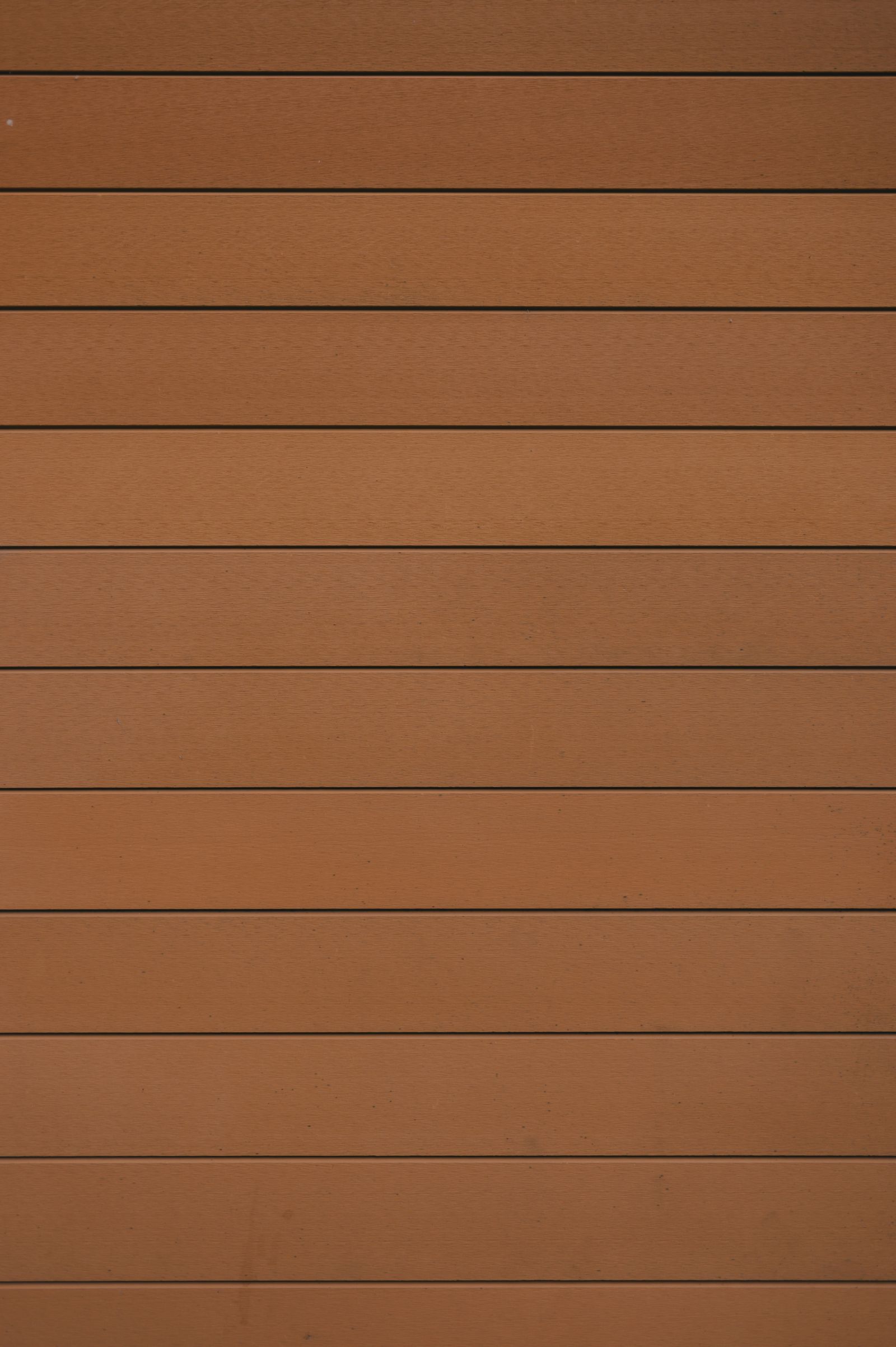 Close-up texture of warm horizontal wood fence planks — illustrative stock photo, not MK Fencing's own material.