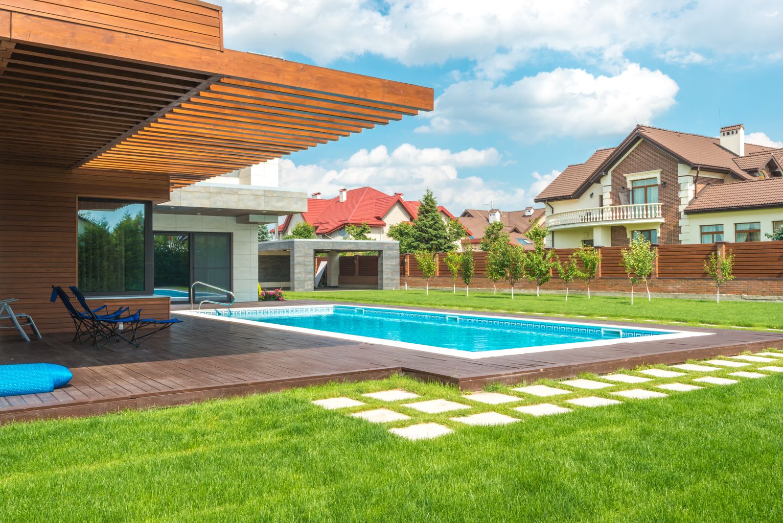 A well-maintained backyard swimming pool under a blue sky — illustrative stock photo, not an actual Sunrise Pool & Spa customer's pool.